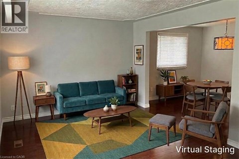 A living room with a blue couch and a wooden coffee table.