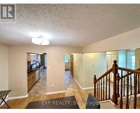 A living room with a staircase leading to the upper floor.