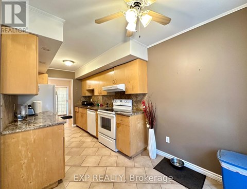 A kitchen with wooden cabinets and a marble countertop.