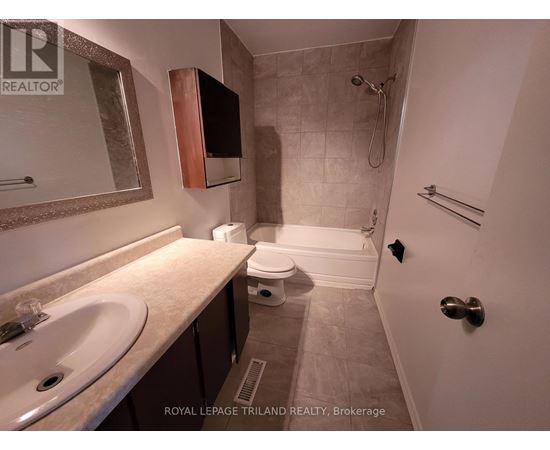 A bathroom with a sink, toilet, and shower.