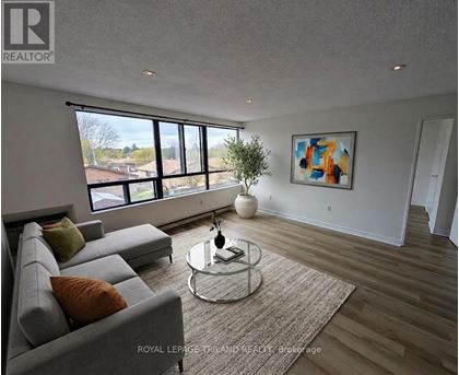 A living room with a grey sofa and a glass coffee table.
