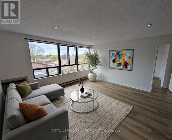 A living room with a grey sofa and a glass coffee table.