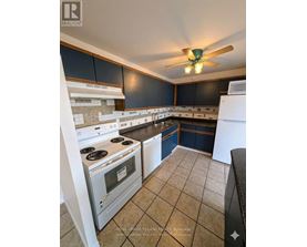 A kitchen with a white stove top oven and a white dishwasher.