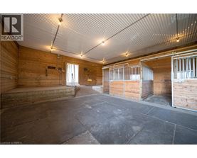 A spacious room with wooden walls and a concrete floor.