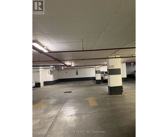 A parking garage with a white car parked in the background.