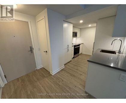 A kitchen area with a sink and a microwave.