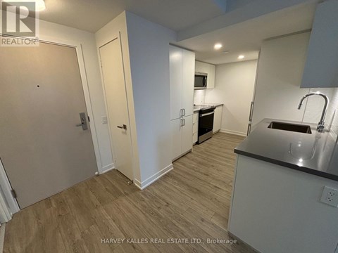 A kitchen area with a sink and a microwave.