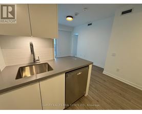 A kitchen with a sink and a dishwasher.