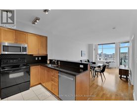 A kitchen with wooden cabinets and black appliances.
