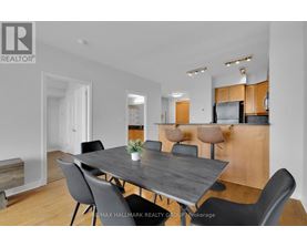 A modern dining room with a large table and chairs.