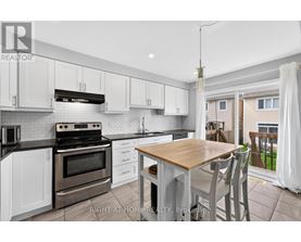 A modern kitchen with a wooden table and chairs.