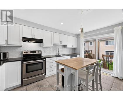 A modern kitchen with a wooden table and chairs.