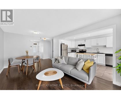 A modern living room with a grey couch and a wooden coffee table.