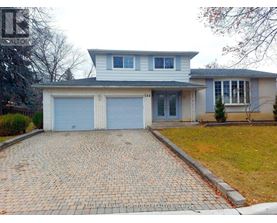 A house with a brick driveway in front of it.