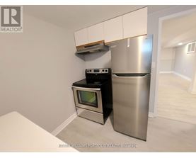 A kitchen with a stainless steel refrigerator and oven.