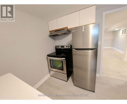 A kitchen with a stainless steel refrigerator and oven.