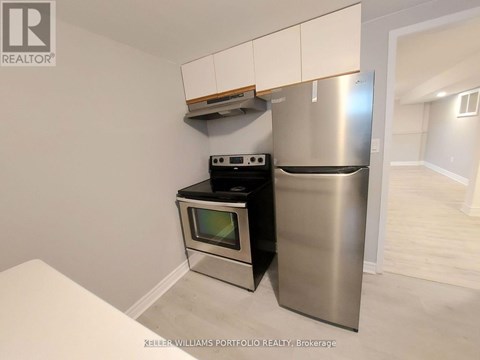 A kitchen with a stainless steel refrigerator and oven.