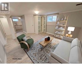 A living room with a white couch, a green chair, and a coffee table.