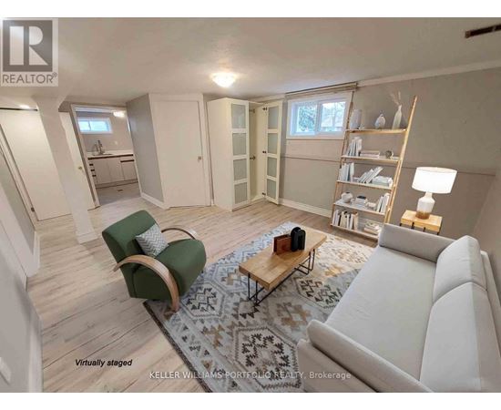 A living room with a white couch, a green chair, and a coffee table.