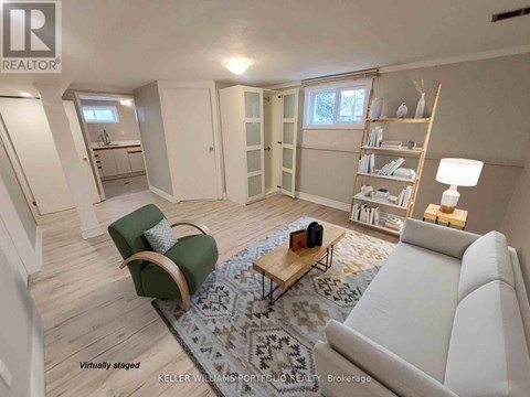 A living room with a white couch, a green chair, and a coffee table.