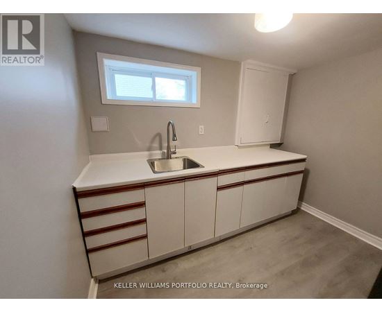 A kitchen with a sink and a window.