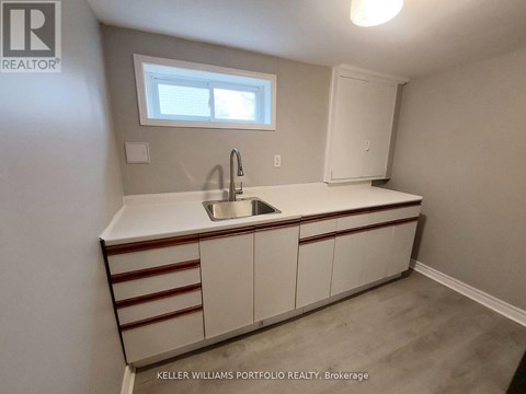 A kitchen with a sink and a window.