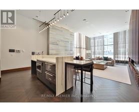 A modern kitchen with a dining table and chairs.