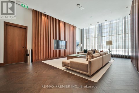 A living room with a couch and a television set.