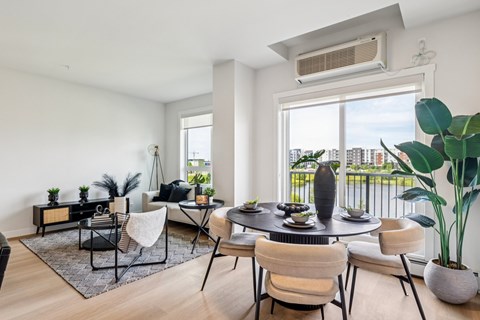 A modern dining room with a table set for six and a view of the city.