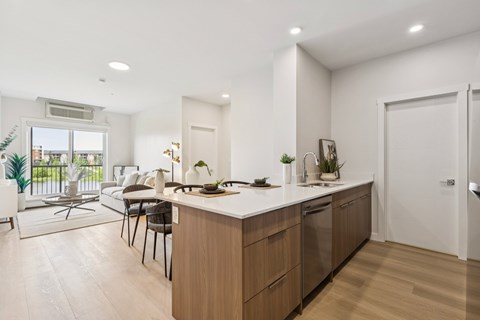 A modern kitchen with wooden cabinets and a white countertop.
