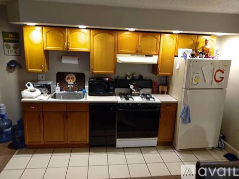 A kitchen with wooden cabinets and a white refrigerator.