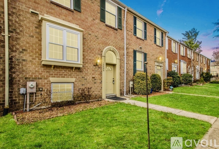 A row of houses with green shutters and a sign that says "available".
