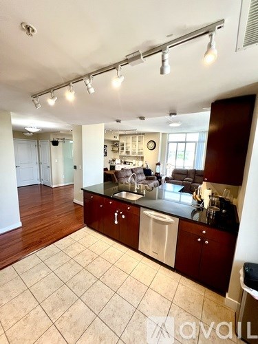 A kitchen with brown cabinets and a black countertop.