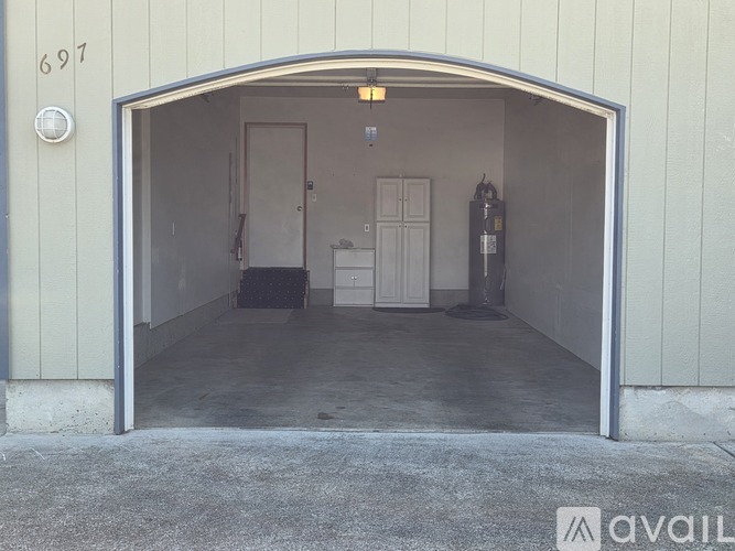 A garage with the number 697 on the wall.