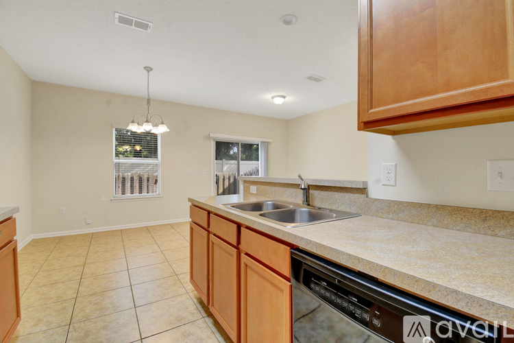 A kitchen with wooden cabinets and a granite countertop.