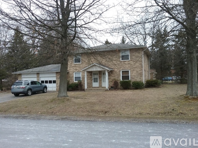 A house with a car parked in front of it.