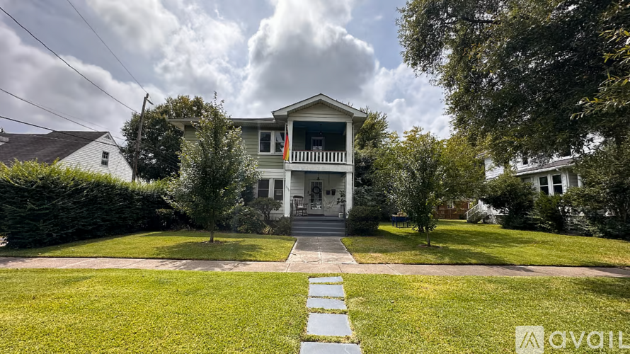 A house with a front yard and a walkway leading to the front door.