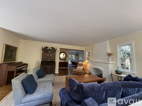 A living room with a grey couch and a blue couch.