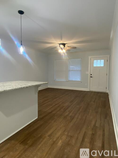 A room with wooden floors and a white ceiling with a light fixture.