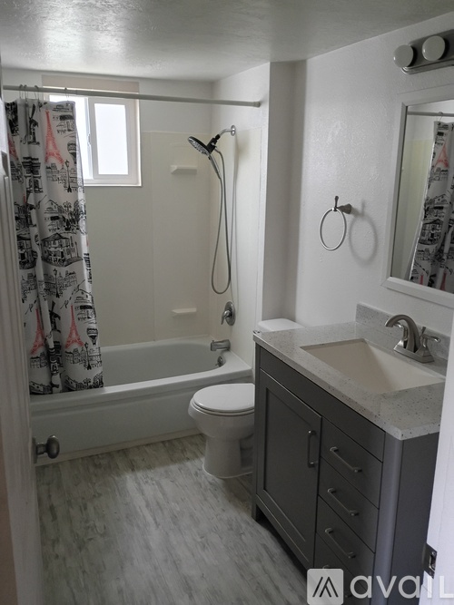 A bathroom with a toilet, sink, and shower.