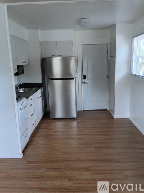 A kitchen with a refrigerator, stove, and oven.