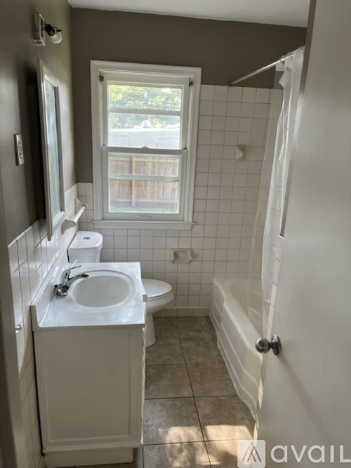A bathroom with a toilet, sink, and bathtub.