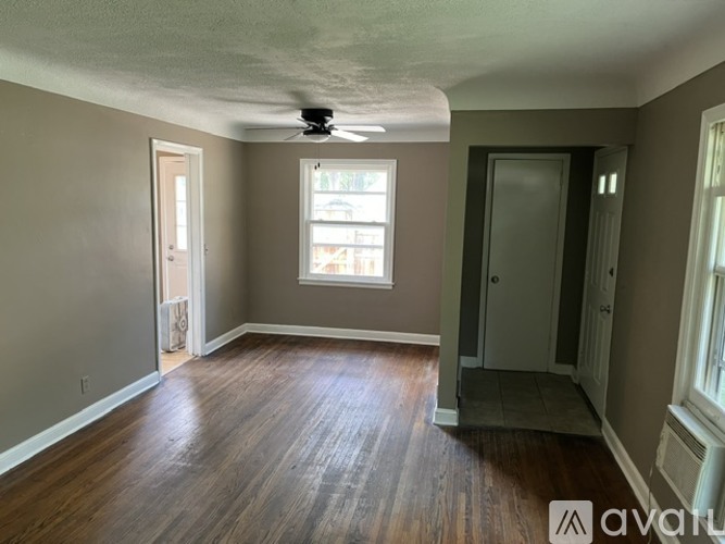 A room with a ceiling fan and a window.