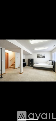 A bedroom with a bed, dresser, and mirror.