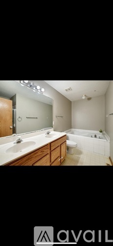 A bathroom with a large mirror and a bathtub.