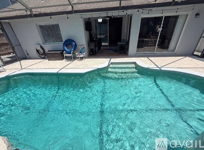 A swimming pool in front of a house.