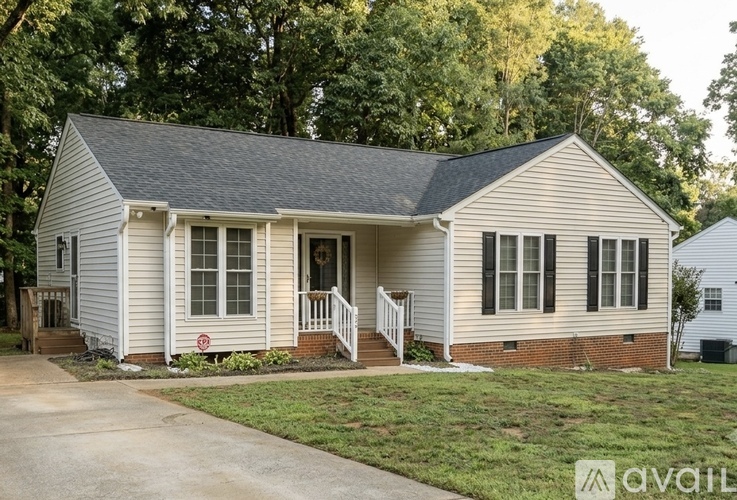 A small house with a porch and a red "no trespassing" sign.