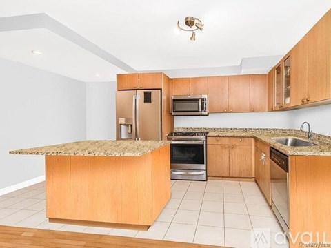 A kitchen with wooden cabinets and a granite countertop.
