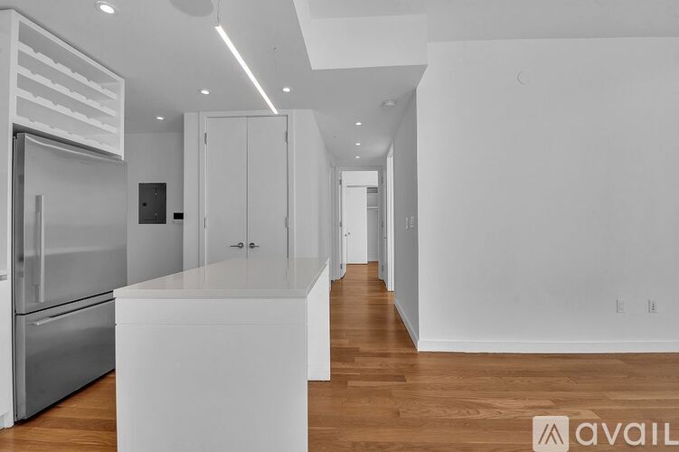 A modern kitchen with white appliances and cabinets.