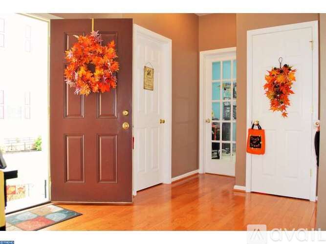 A brown door with a wreath on it.